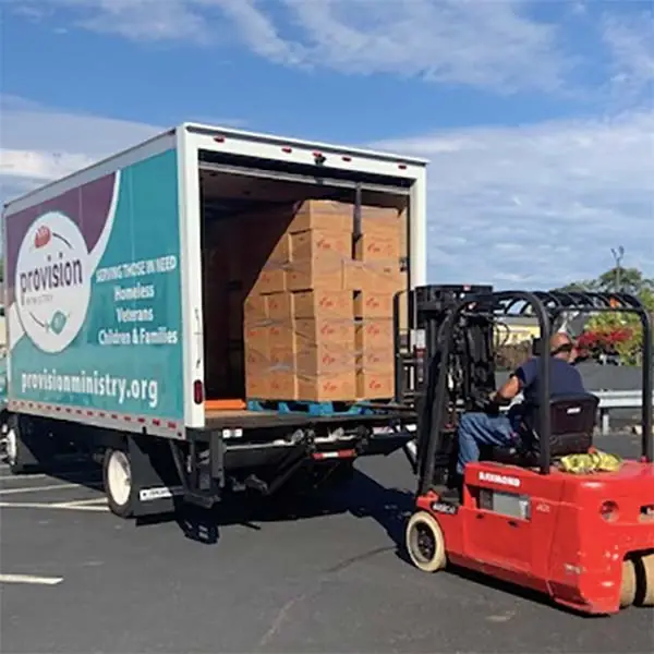 Forklift loading truck with supplies